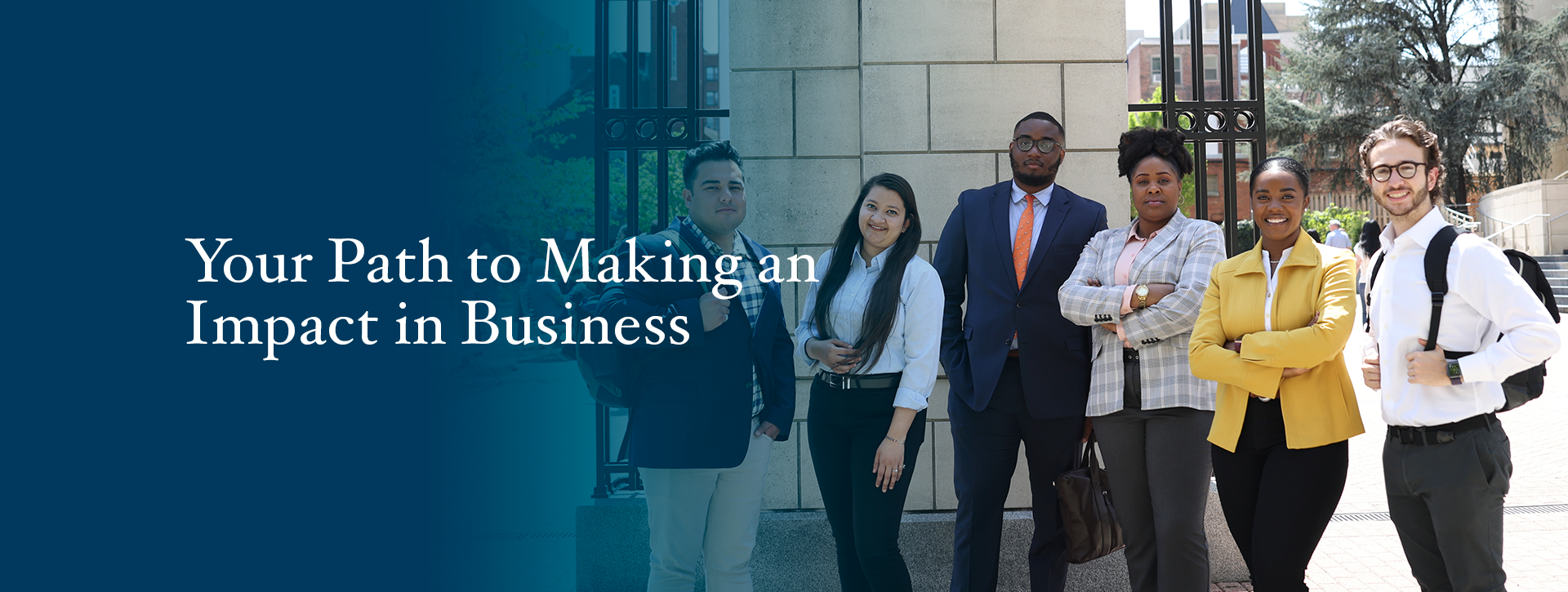Your Path to Making an Impact in Business. Image shows six smiling GW School of Business studnets standing in the sunshine in front of Kogan Plaza on the GW University campus.
